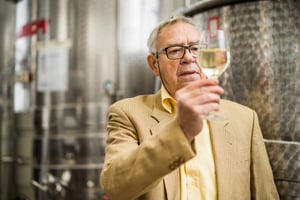 FWM - Man looking at wine in glass